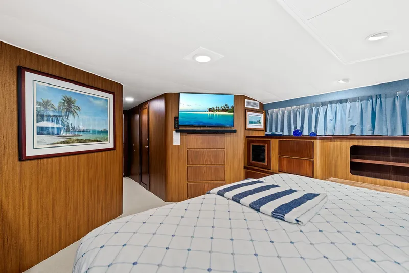 Slide: The Image of Luxurious bedroom interior of a 1989 Hatteras 70 Motor Yacht with modern amenities. - 38