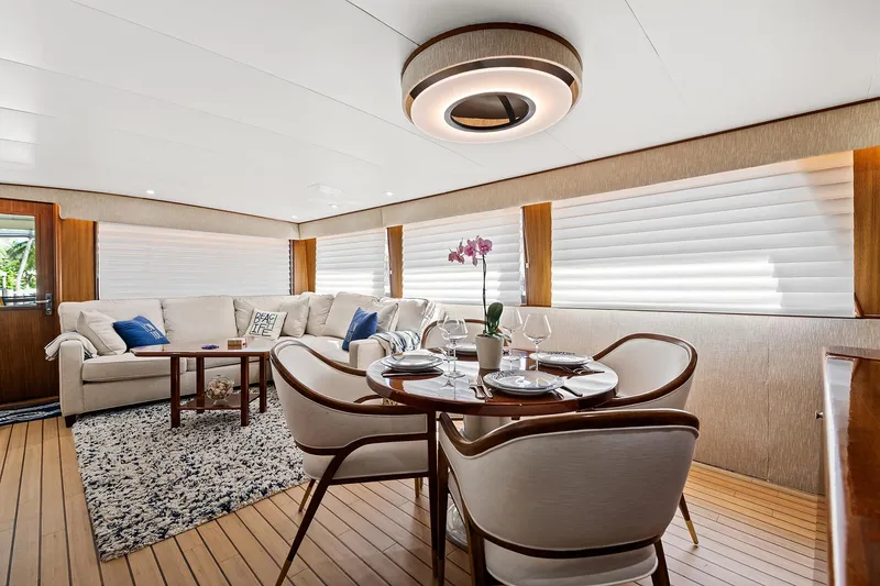 Slide: The Image of Luxurious interior of 1989 Hatteras 70 Motor Yacht with elegant dining and seating areas. - 9