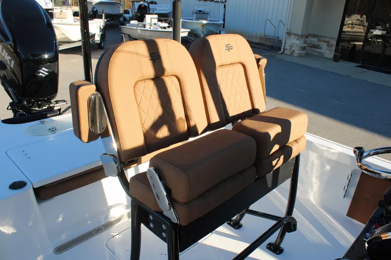 Slide: The Image of 2025 Sea Pro 250 Bay boat with tan cushioned seating and sleek design. - 13