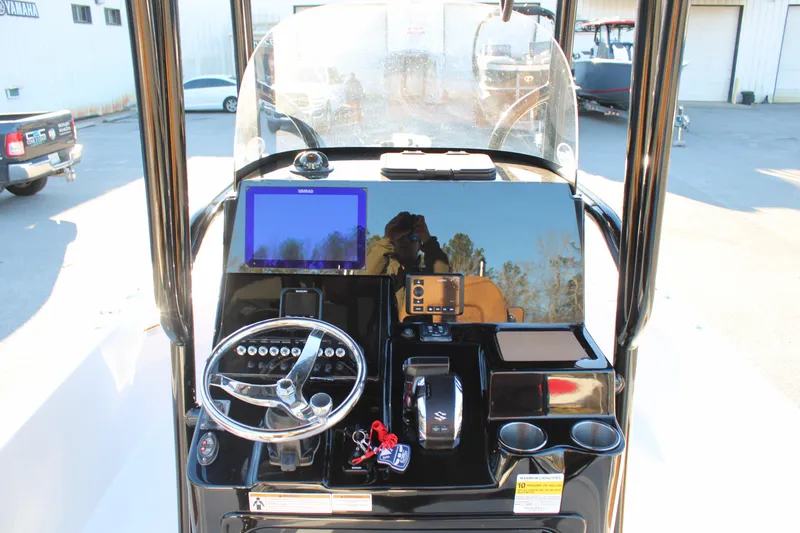 Slide: The Image of 2025 Sea Pro 250 Bay boat dashboard with steering wheel and navigation display. - 15