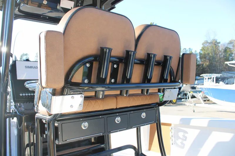 Slide: The Image of 2025 Sea Pro 250 Bay boat seating with rod holders and storage drawers. - 19