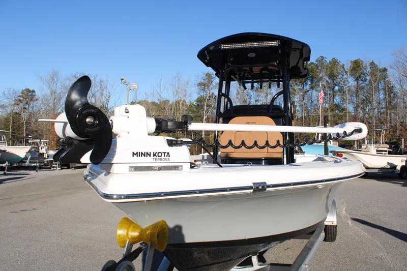 Slide: The Image of 2025 Sea Pro 250 Bay boat with Minn Kota Terrova motor, parked on a trailer. - 2