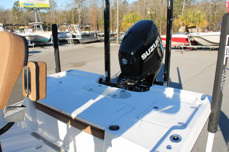 Slide: The Image of 2025 Sea Pro 250 Bay boat with Suzuki outboard motor in a marina setting. - 23