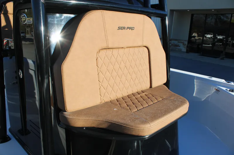Slide: The Image of 2025 Sea Pro 250 Bay boat seat with tan upholstery and diamond stitching. - 24