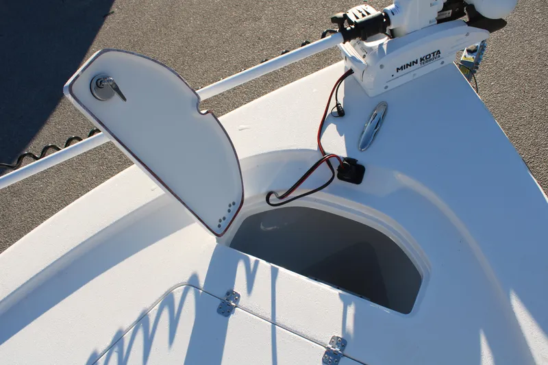 Slide: The Image of 2025 Sea Pro 250 Bay boat with open storage compartment and Minn Kota trolling motor. - 6