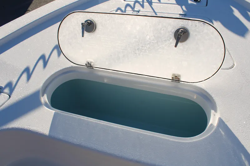 Slide: The Image of 2025 Sea Pro 250 Bay boat storage compartment with open lid, showcasing interior space. - 7
