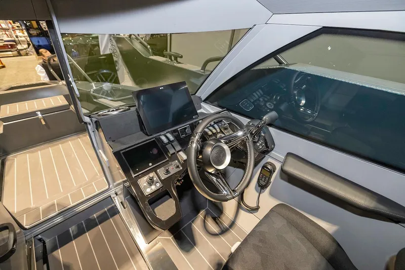 Slide: The Image of 2024 G-Force G-Force 8 boat cockpit with modern steering wheel and navigation system. - 21