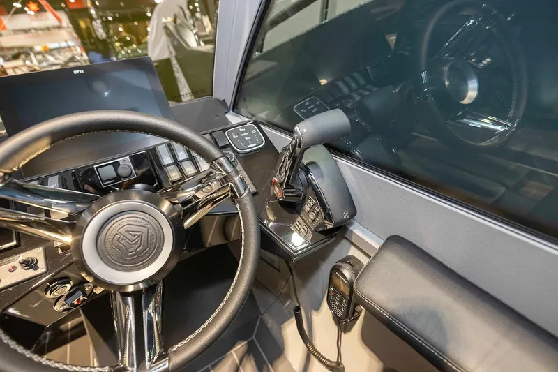 Slide: The Image of 2024 G-Force 8 boat cockpit with steering wheel and control panel. - 23