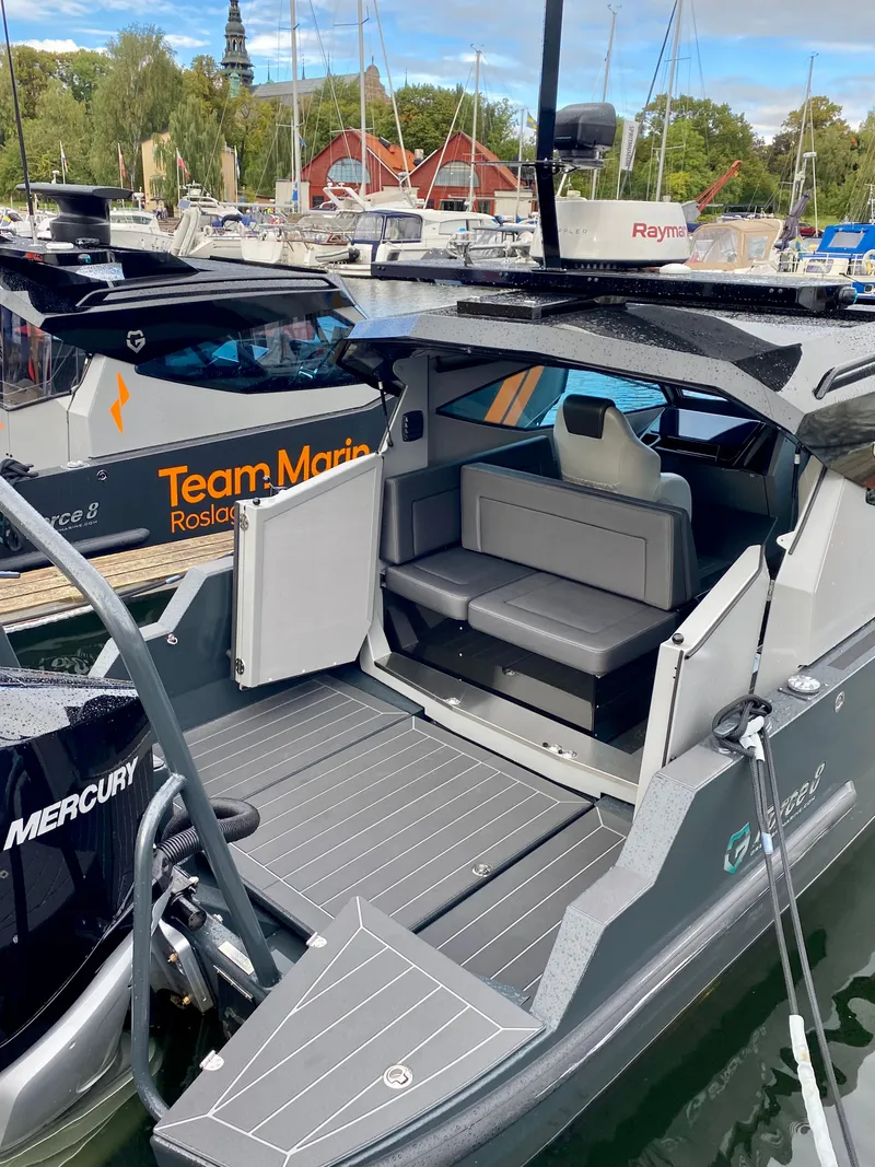 Slide: The Image of 2024 G-Force 8 boat with open seating area docked at marina. - 26