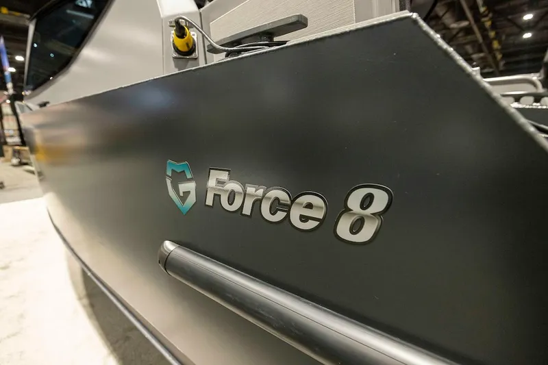 Slide: The Image of Close-up of 2024 G-Force G-Force 8 logo on a sleek black surface. - 6