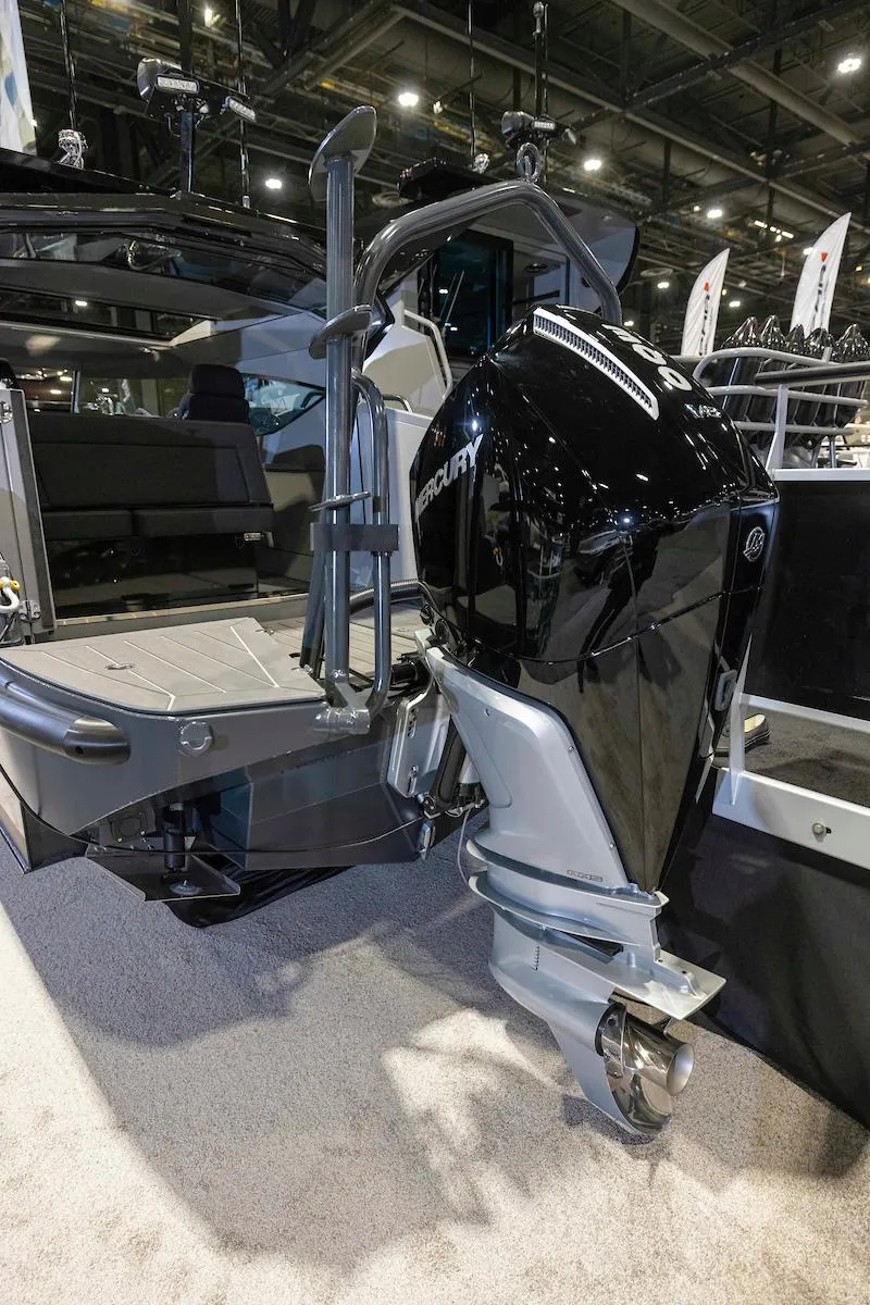 Slide: The Image of 2024 G-Force 8 boat with powerful outboard motor displayed at a boat show. - 8