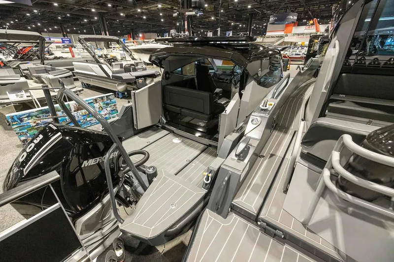 Slide: The Image of 2024 G-Force G-Force 8 boat interior at a boat show, featuring Mercury engine. - 9