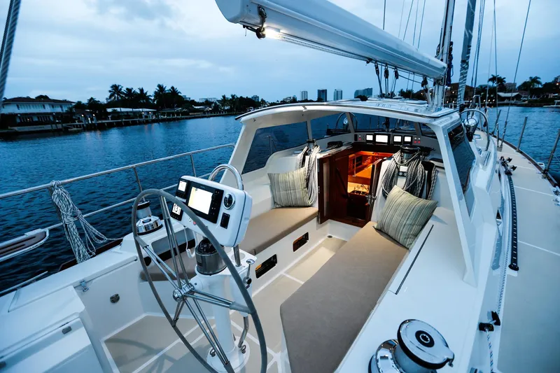 Slide: The Image of Luxurious 2025 Outbound 46 yacht interior with modern cockpit and serene waterfront view. - 10