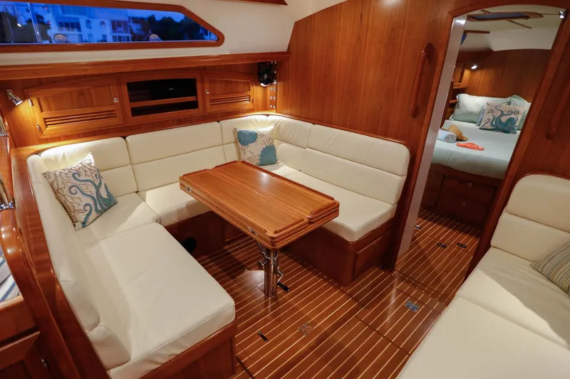 Slide: The Image of Luxurious interior of 2025 Outbound 46 yacht with elegant wood finish and cozy seating area. - 17