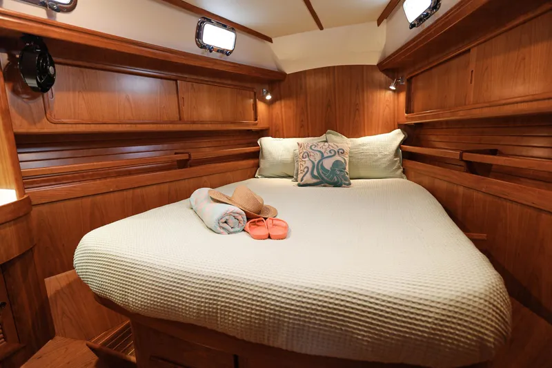 Slide: The Image of Luxurious cabin interior of 2025 Outbound 46 yacht with cozy bedding and wooden finish. - 21