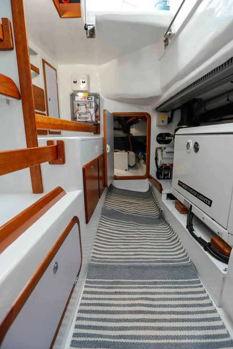 Slide: The Image of Interior of 2025 Outbound 46 yacht with modern design and striped carpet. - 24