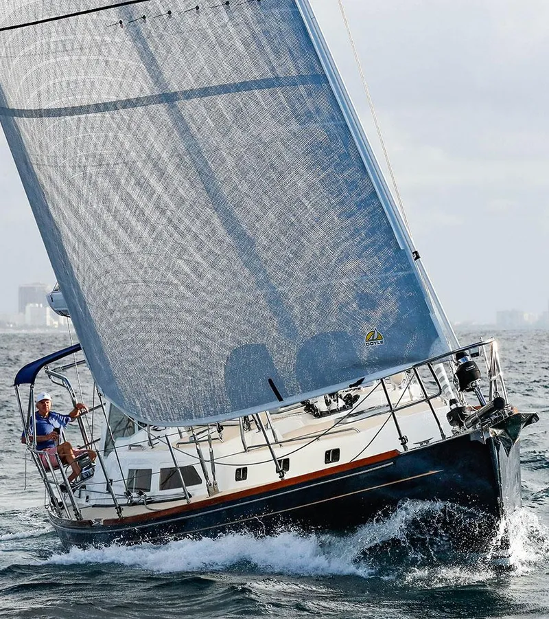 Slide: The Image of Outbound 46 sailboat from 2025 navigating ocean waves under full sail. - 4