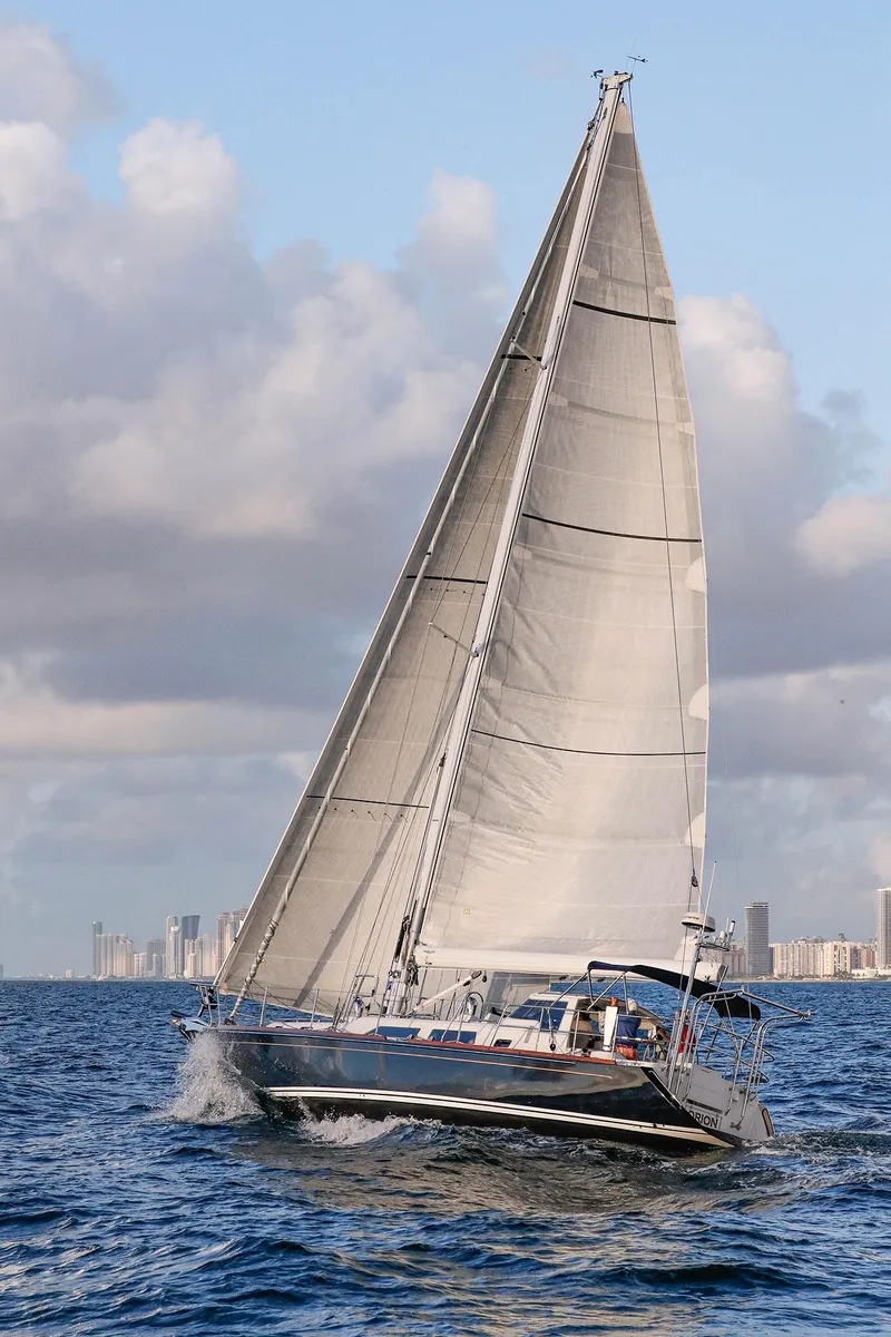 Slide: The Image of Sailing yacht Outbound 46, 2025 model, cruising on open water under a cloudy sky. - 5