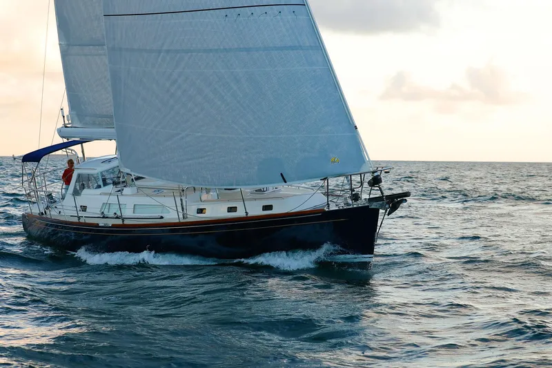 Slide: The Image of Sailing yacht Outbound 46, 2025 model, cruising on open sea at sunset. - 8