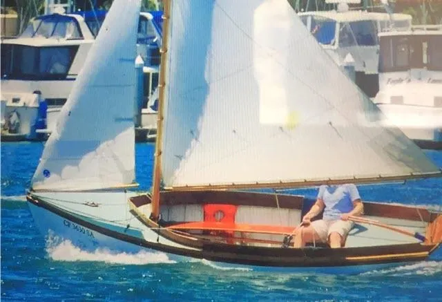 Slide: The Image of 1994 Custom Haven 12.5 sailboat cruising in a marina with other boats in the background. - 1