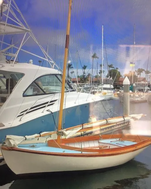 Slide: The Image of Custom Haven 12.5 sailboat, 1994 model, docked in a marina with other boats. - 2