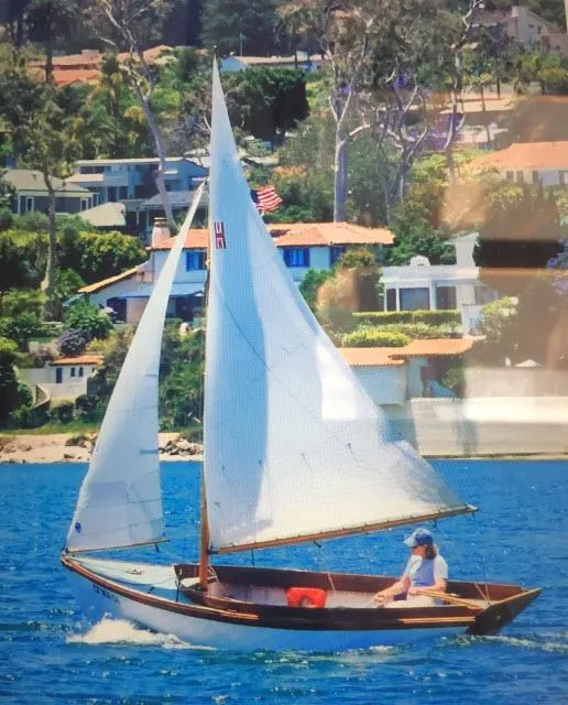 Slide: The Image of Sailboat Custom Haven 12.5 1994 gliding on blue water near coastal homes. - 5