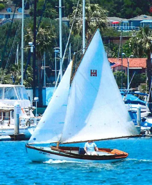 Slide: The Image of Sailboat Custom Haven 12.5 1994 model sailing in a marina with lush greenery. - 7