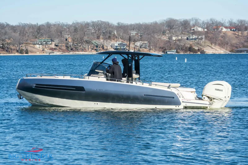Slide: The Image of 2024 Invictus TT280S boat cruising on a lake with scenic background. - 18