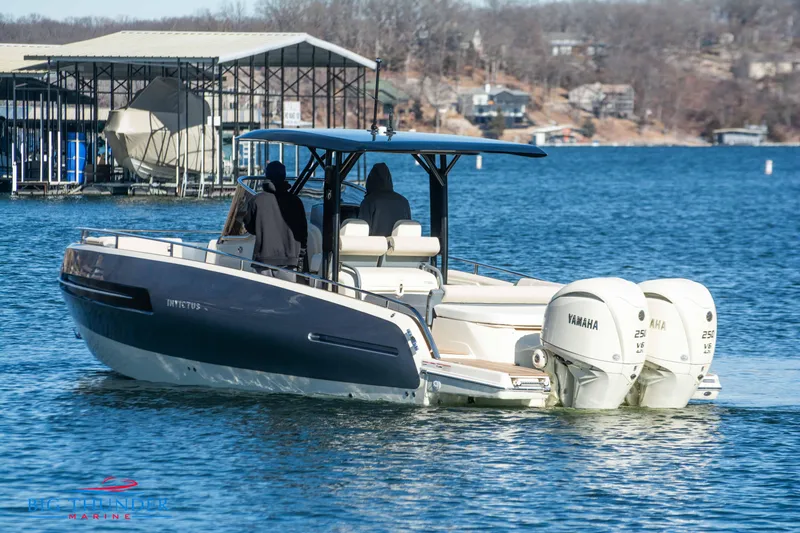 Slide: The Image of 2024 Invictus TT280S boat with dual Yamaha engines on a lake. - 19