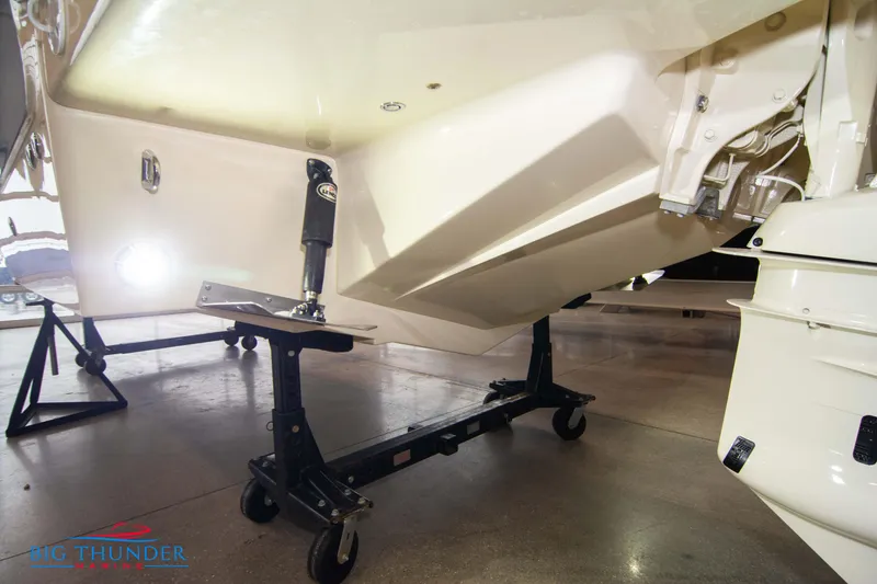 Slide: The Image of 2024 Invictus TT280S boat hull on a stand in a showroom. - 28