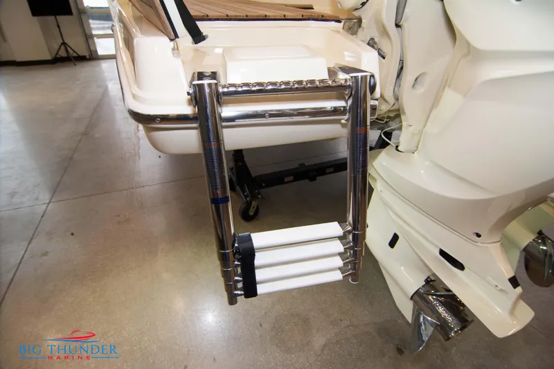 Slide: The Image of 2024 Invictus TT280S boat with extended swim ladder in a showroom. - 29