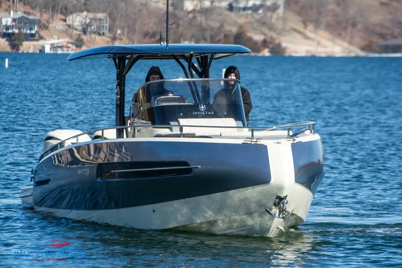 Slide: The Image of 2024 Invictus TT280S luxury motorboat cruising on a serene lake. - 3