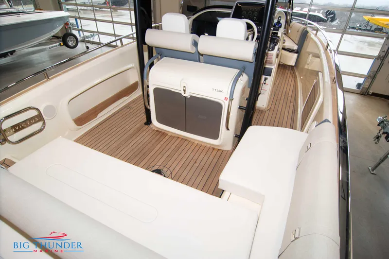 Slide: The Image of 2024 Invictus TT280S boat interior with teak flooring and white seating at Big Thunder Marine. - 34