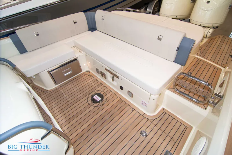 Slide: The Image of 2024 Invictus TT280S boat interior with teak flooring and cushioned seating. - 37