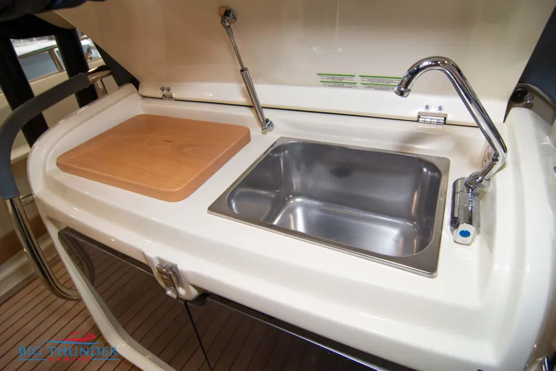 Slide: The Image of 2024 Invictus TT280S boat kitchen sink and cutting board. - 42