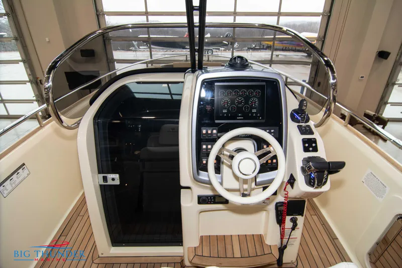 Slide: The Image of 2024 Invictus TT280S boat helm with advanced navigation controls and steering wheel. - 46