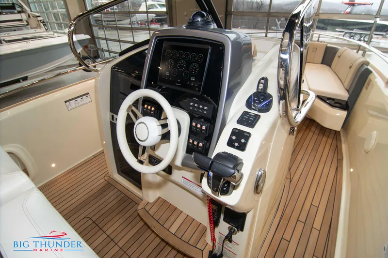 Slide: The Image of 2024 Invictus TT280S boat helm with advanced controls and teak flooring at Big Thunder Marine. - 49