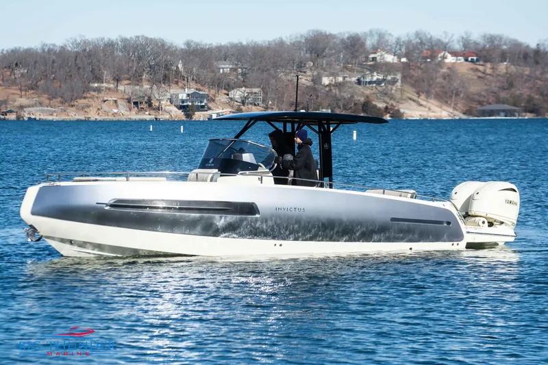 Slide: The Image of 2024 Invictus TT280S luxury motorboat cruising on a lake. - 6