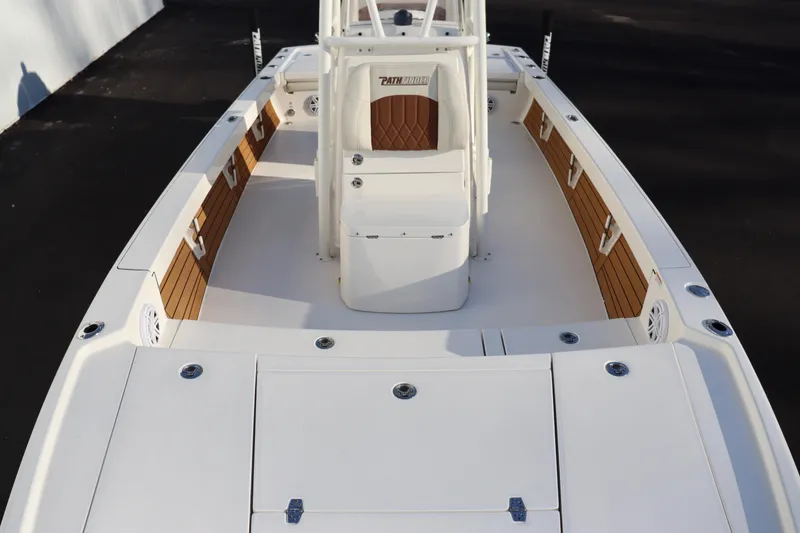 Slide: The Image of 2024 Pathfinder 2500 Hybrid boat interior with white and wood accents. - 11