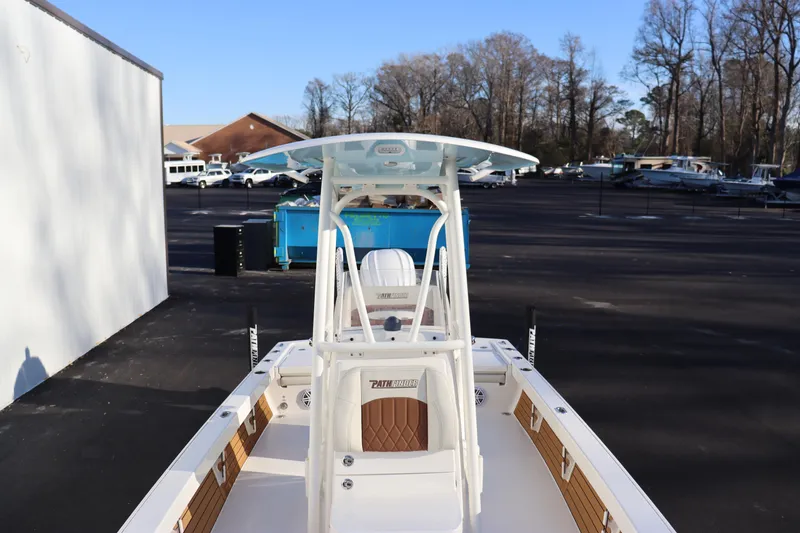 Slide: The Image of 2024 Pathfinder 2500 Hybrid boat in a parking lot with trees in the background. - 12