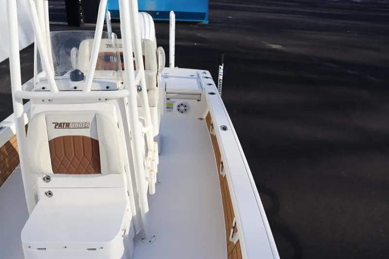 Slide: The Image of 2024 Pathfinder 2500 Hybrid boat interior with white and brown seating. - 14