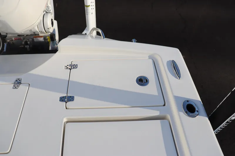 Slide: The Image of 2024 Pathfinder 2500 Hybrid boat deck with storage compartments and fishing rod holders. - 19