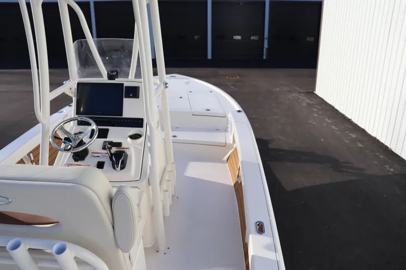Slide: The Image of 2024 Pathfinder 2500 Hybrid boat cockpit with steering wheel and navigation system. - 27