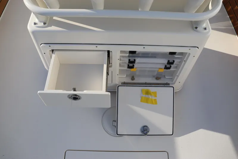 Slide: The Image of 2024 Pathfinder 2500 Hybrid boat storage compartments and tackle box. - 29