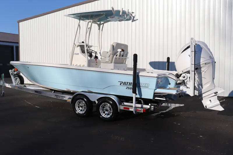 Slide: The Image of 2024 Pathfinder 2500 Hybrid boat on trailer, light blue hull, outboard motor. - 3