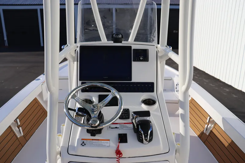Slide: The Image of 2024 Pathfinder 2500 Hybrid boat console with steering wheel and navigation system. - 30