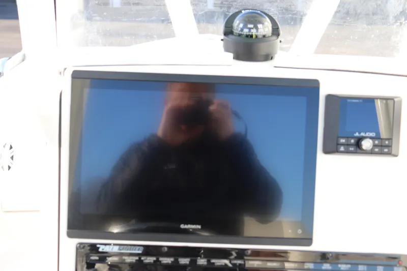 Slide: The Image of 2024 Pathfinder 2500 Hybrid boat dashboard with Garmin display and JL Audio system. - 32