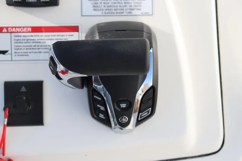 Slide: The Image of 2024 Pathfinder 2500 Hybrid boat throttle control with warning labels. - 36