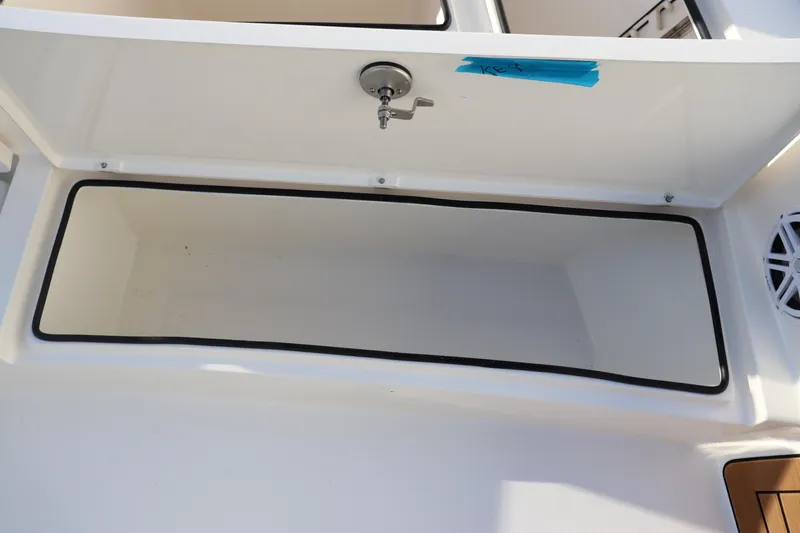 Slide: The Image of 2024 Pathfinder 2500 Hybrid boat storage compartment with open lid. - 40