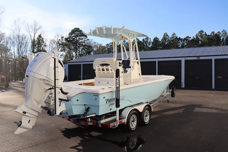 Slide: The Image of 2024 Pathfinder 2500 Hybrid boat on trailer, rear view, outdoor storage facility. - 6